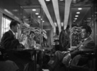 Strangers on a Train (1951) - Film frame from ''Strangers on a Train''. Guy is reading a copy of ''Alfred Hitchcock's Fireside Book of Suspense Stories''.
