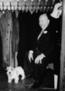 Alfred Hitchcock (1952) - Photograph of Alfred Hitchcock and one of his Sealyham Terriers at the wedding of his daughter Patricia in January 1952.